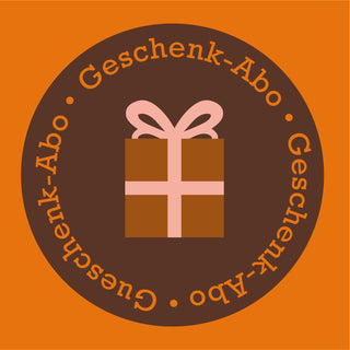 Grafisches Icon zum AMORI Geschenk-Abo mit Geschenkpaket und umlaufender Beschriftung ohne Zahl für die Laufzeit.
